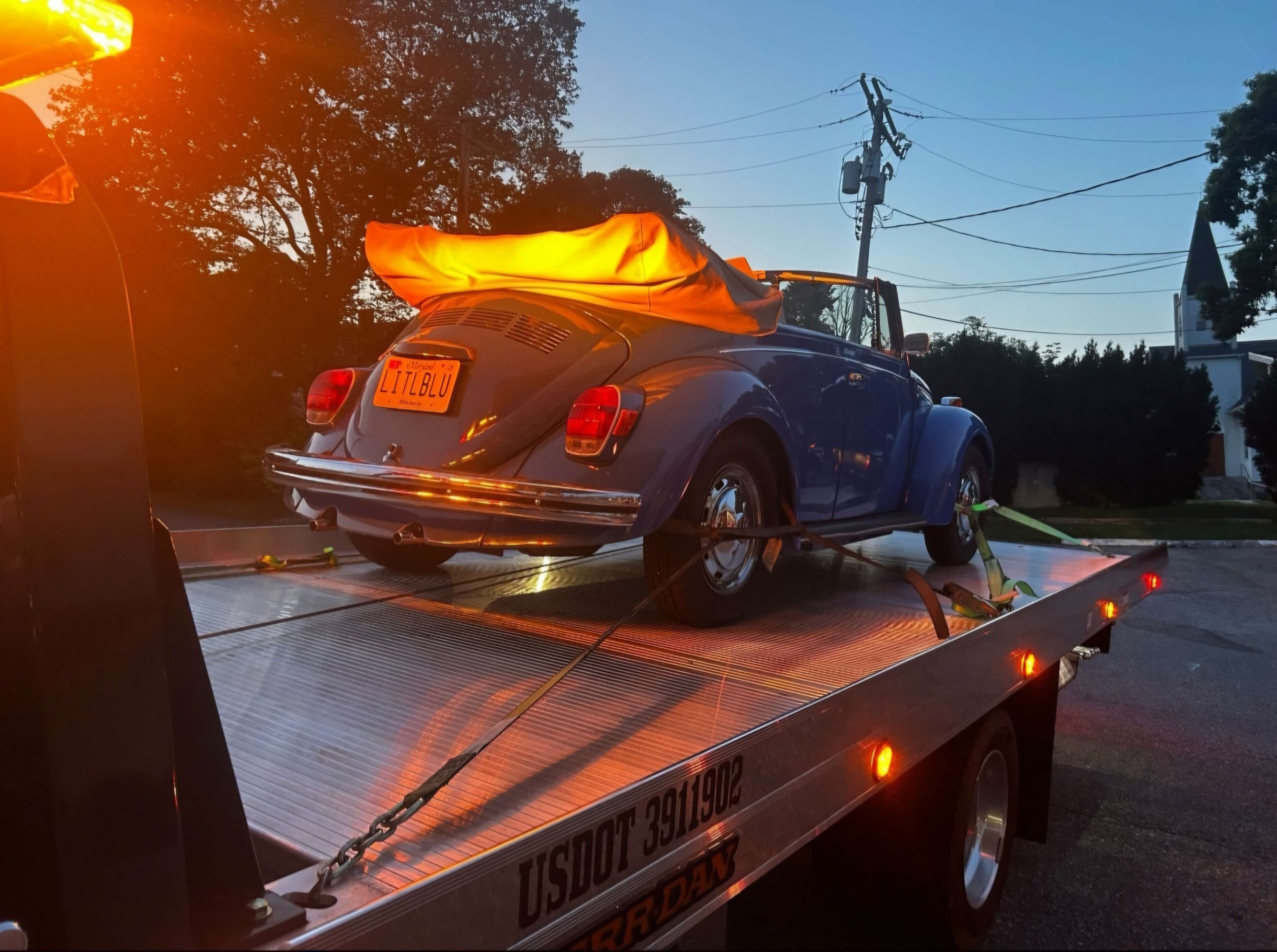 Flatbed tow truck loading a car